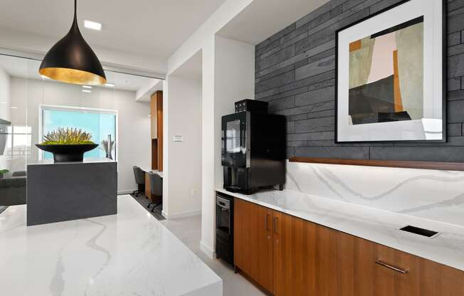 a kitchen with a marble counter top and a black tv