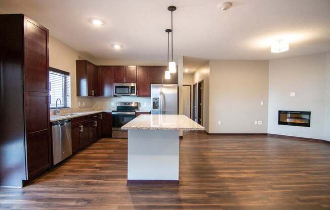 Kitchen and living room with hardwood-style flooring at 360 at Jordan West