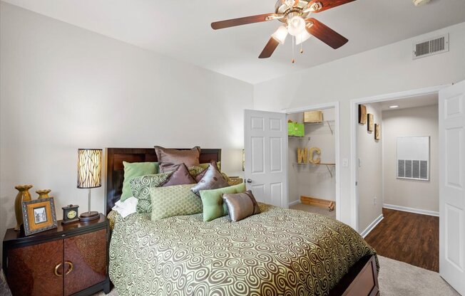 a bedroom with a bed and a ceiling fan