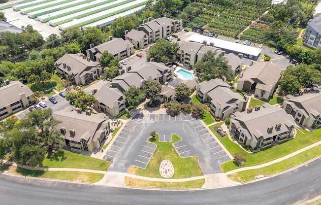 A bird's eye view of a residential area with houses and a roundabout.