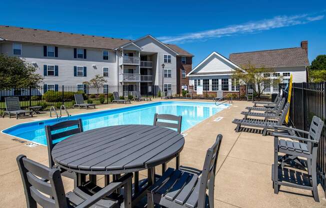 our apartments offer a swimming pool with a table and chairs