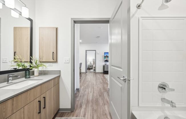 a bathroom with a shower and a sink and a mirror