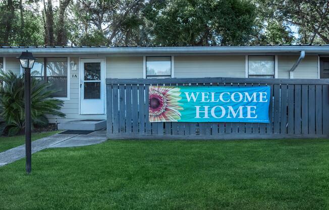 a sign in front of a house