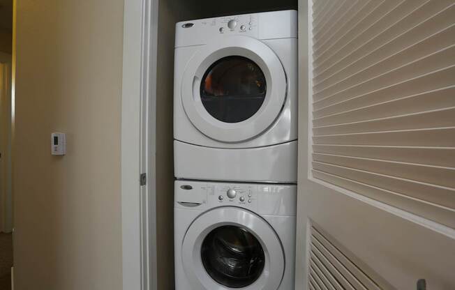 a front loading washer and dryer in a laundry room