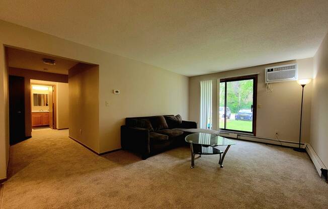 a living room with a couch and a glass coffee table