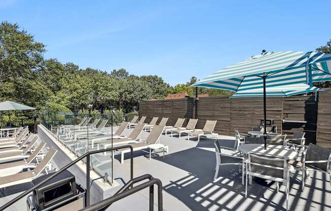 A sunny day at the outdoor pool area with sun loungers and a shade structure.