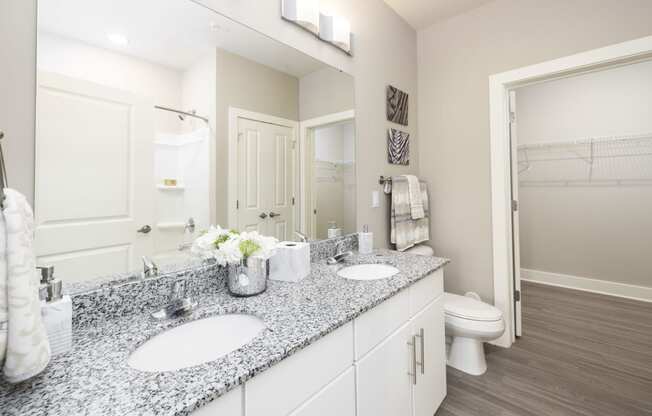 a white bathroom with two sinks and a mirror