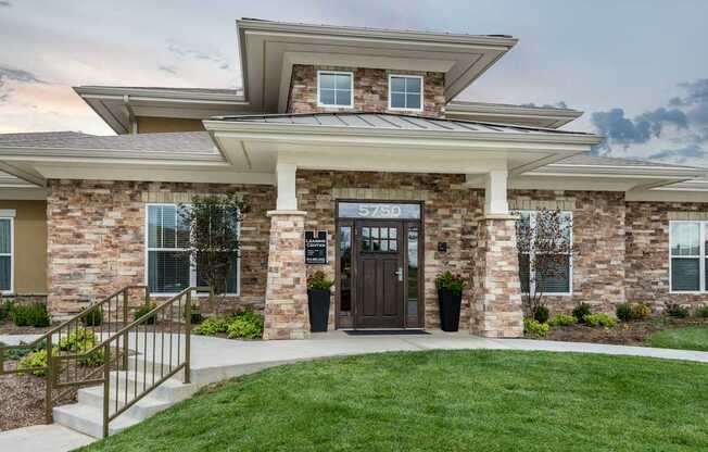 A modern house with a stone facade and a wooden door.