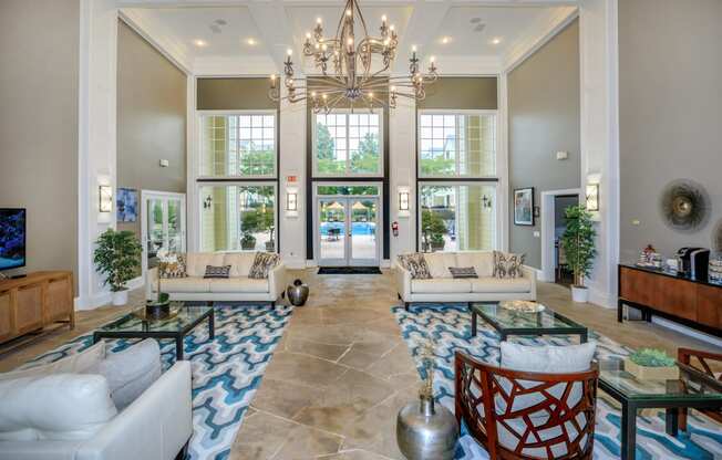 a large living room with couches and a chandelier