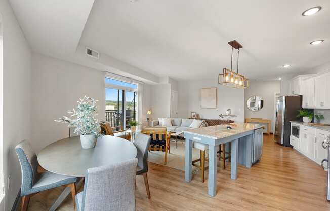 a living room and dining room with a blue table and chairs