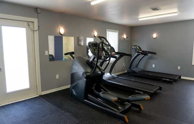 a room with a treadmill and a mirror