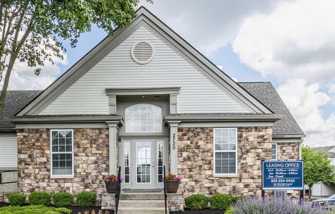 a home with a blue sign in front of it