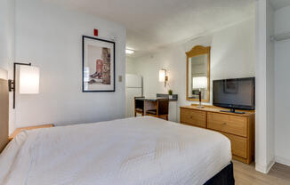 a bedroom with a bed and a tv in a hotel room  at Waterford Studios, Austin, Texas