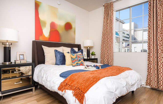 spacious bedroom with large windows at the district flats apartments in lenexa