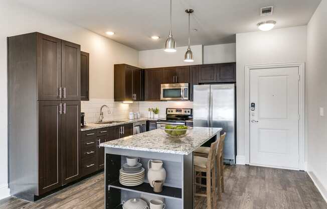 a kitchen with stainless steel appliances and a marble counter top