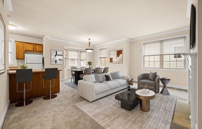 A living room with a white couch, a coffee table, and a television.