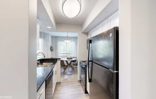 a kitchen with stainless steel appliances and a dining room with a table