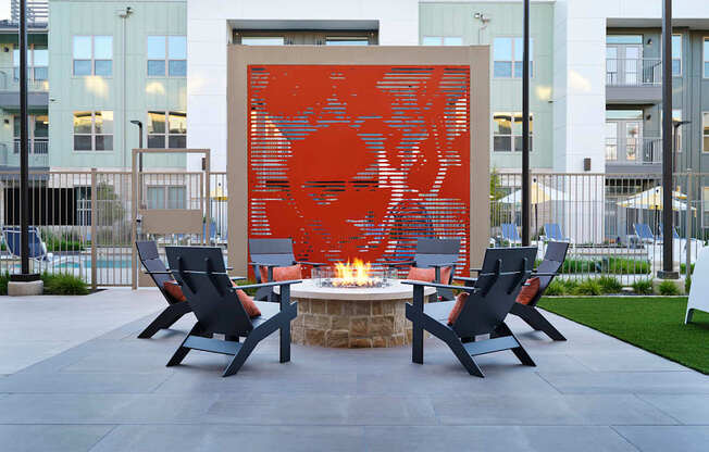 an outdoor patio with chairs and a fire pit