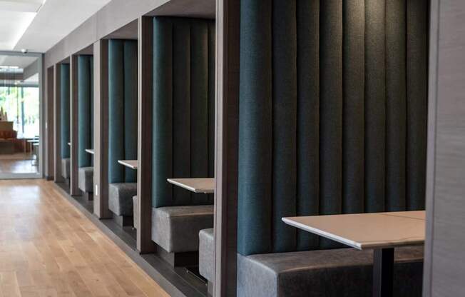 A long hallway with tables and benches on either side.