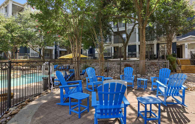 Outdoor seating near the pool at Encore at Buckingham Apartments in Richardson, TX