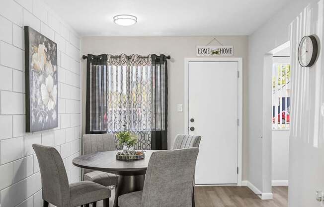 A dining room with a table and chairs.