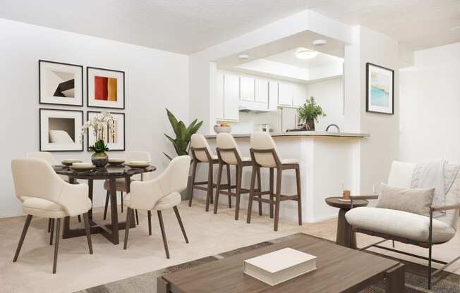 a living room and dining room with a table and chairs