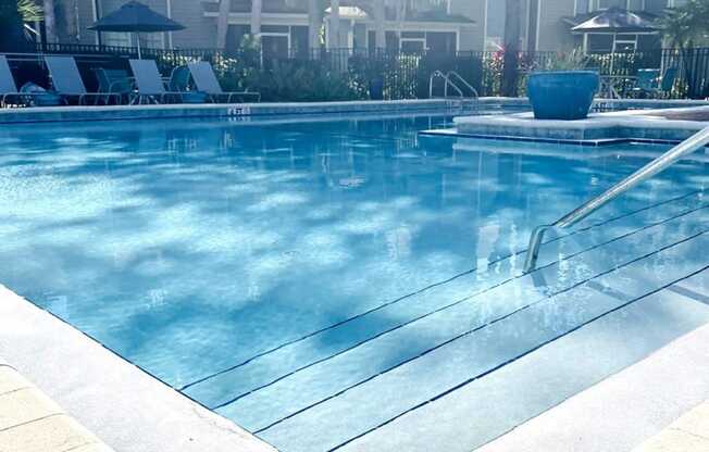 a swimming pool with a bunch of chairs in it