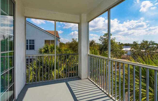 the view from the balcony of a home with large windows