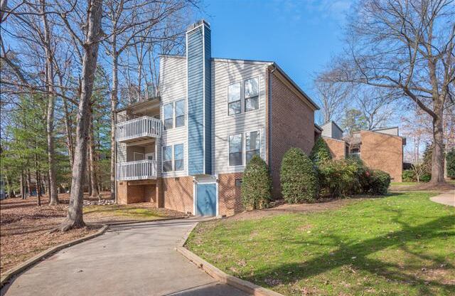 a building with a blue door and a green lawn