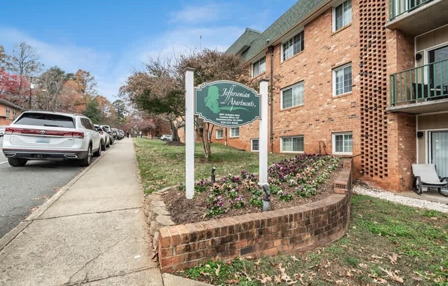 A sign for a community named "Hometown Heights" is displayed in front of a brick building.