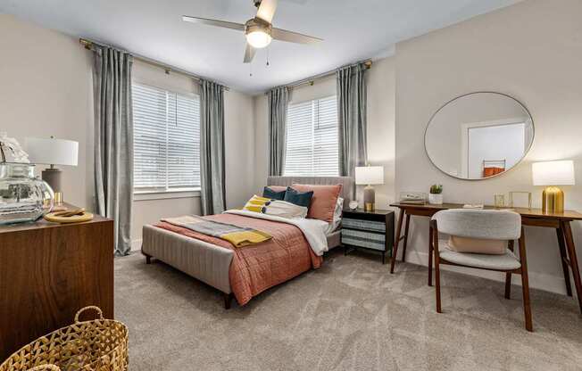 A bedroom with a bed, desk, and chair.