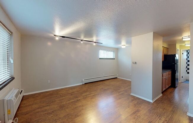 Spacious living area with hardwood floors