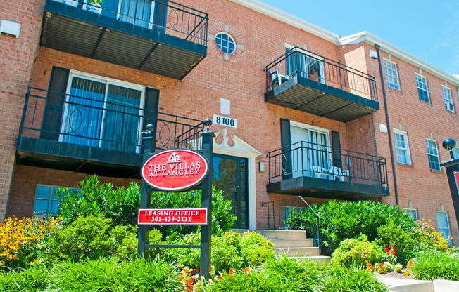 a brick building with a red sign in front of it