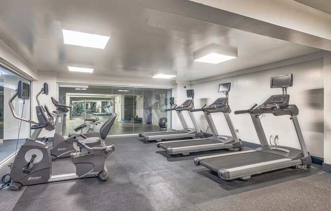 a gym with treadmills and other exercise equipment