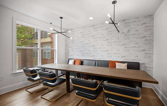 A white brick wall with a wooden table and chairs in front of it.