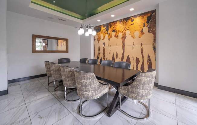 a conference room with a long table and chairs and a mural on the wall at The Hendrix, Atlanta, GA