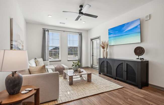 an open living room with a fireplace and a ceiling fan at Stella, San Tan Valley, AZ 85143