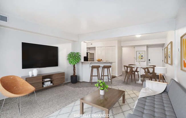 A modern living room with a flat screen TV, a wooden chair, a coffee table, and a grey sofa at West Hampton Park Apartments in Elkhorn, NE 68022