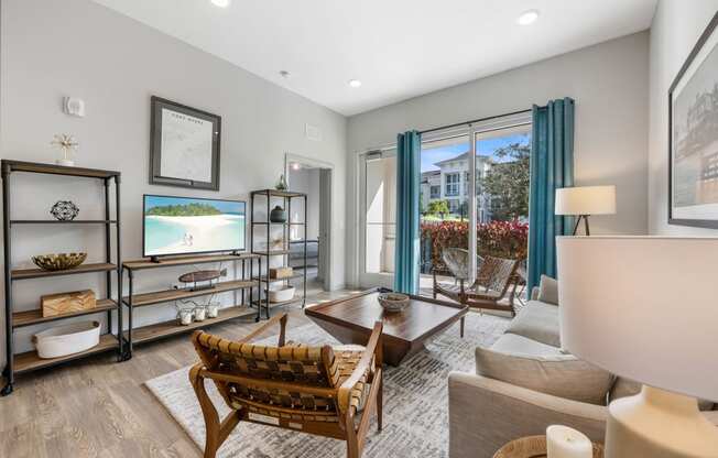 a living room with a couch and chairs and a tv