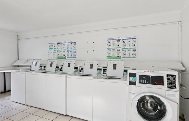 A row of washing machines in a laundromat.