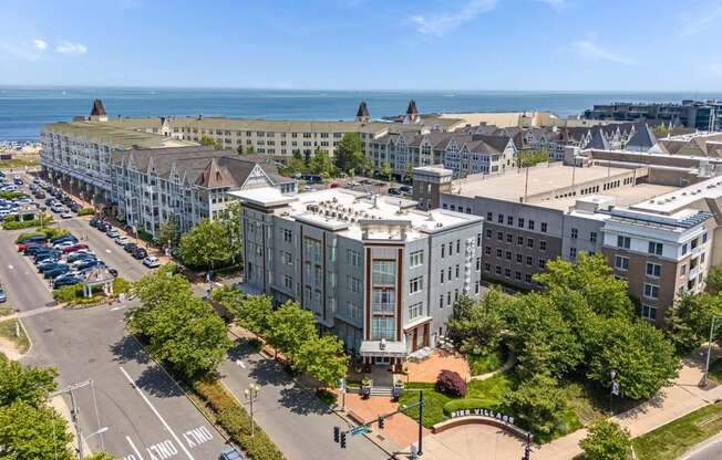 A large white building with a green lawn in front of it.