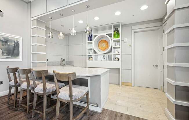 A kitchen with a table and chairs.