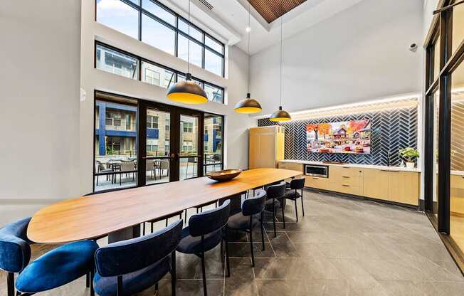 Private dining kitchen with a long table and blue chairs.