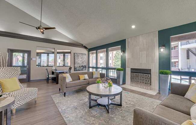A living room with a fireplace and a ceiling fan.