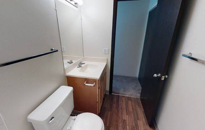 Bathroom with sink next to toilet on one side