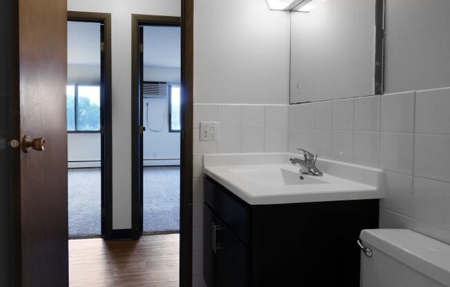 a bathroom with a toilet sink and mirror