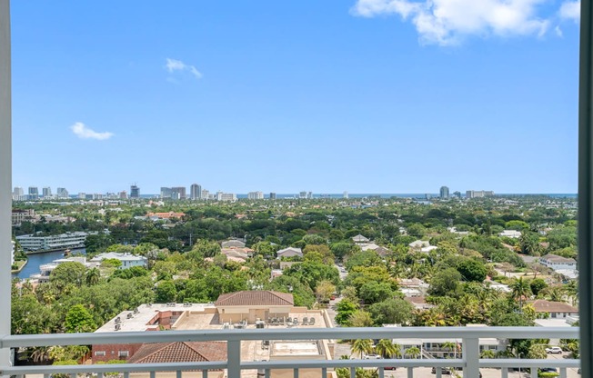 the view of the city from the balcony of a condo