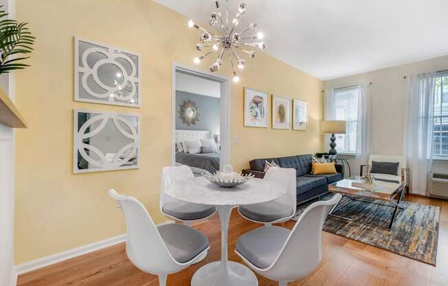 a living room with a couch and a table with chairs at Pier Village Apartments, Long Branch, New Jersey