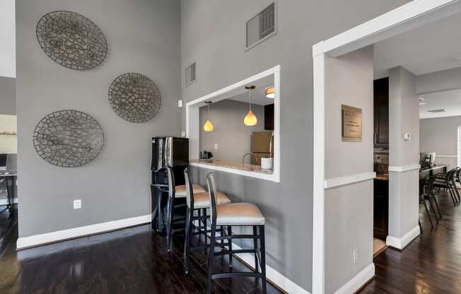 a bar area with stools and a refrigerator in a 555 waverly unit at Misty Ridge Apartments, Woodbridge, 22191