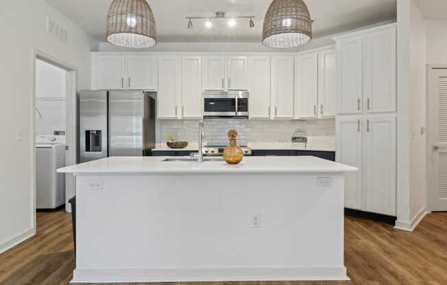 a kitchen with white cabinets and a white counter top